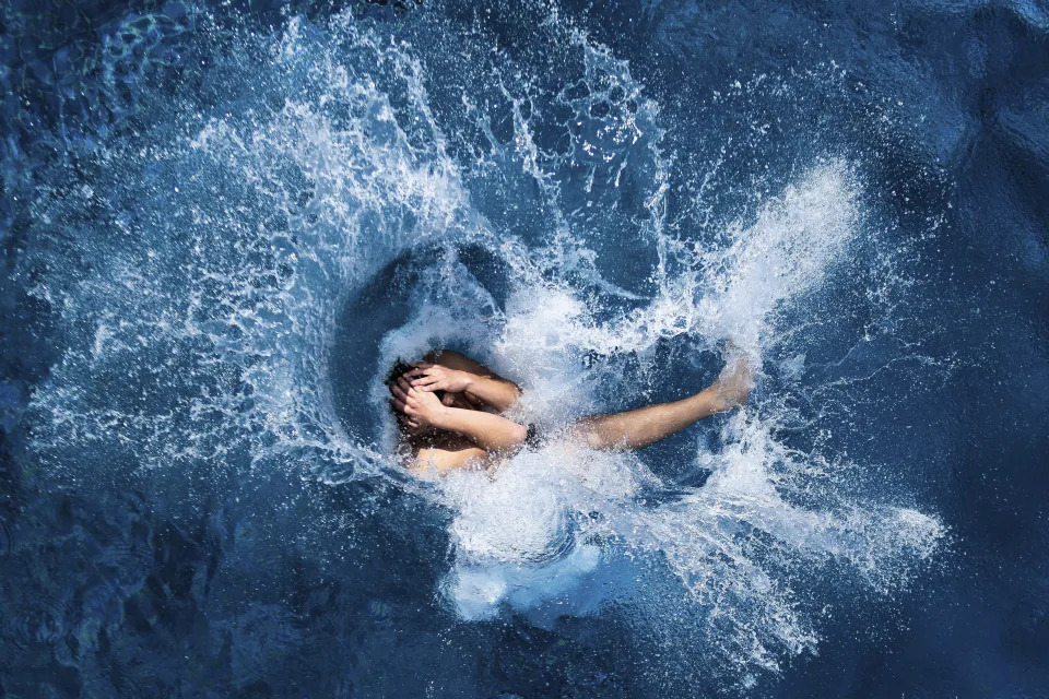 A boy jumps into the water at the Olympic open air public pool in Berlin, Germany, May 21, 2014. Women in Berlin will soon be allowed to go topless at the city's public pools, the Berlin state government said Thursday. The new bathing rules to allow both men and women to go swimming without covering their upper bodies came in reaction to a woman's complaint alleging discrimination because she was not allowed to swim topless in a swimming pool in Berlin, like men. (AP Photo/Markus Schreiber, File)