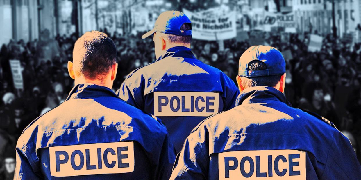 Police officers standing in front of protestors