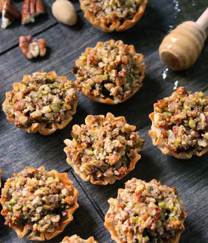 <p>A Gouda Life</p><p>Mini phyllo cups filled with three kinds of nuts blanketed in an irresistible, buttery honey-cinnamon blend. All the delicious flavor as the full size classic dessert but way less work!</p><p><strong>Get the recipe: <a href="https://www.agoudalife.com/mini-baklava-cups/" rel="nofollow noopener" target="_blank" data-ylk="slk:Mini Baklava Cups;elm:context_link;itc:0;sec:content-canvas" class="link rapid-noclick-resp"><em>Mini Baklava Cups</em></a></strong></p>