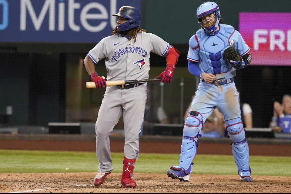 Toronto Blue Jays' Vladimir Guerrero Jr., left, and Texas Rangers catcher Jonah Heim react after the final strike ending the baseball game in Arlington, Texas, Sunday, Sept. 11, 2022. The Rangers won 4-1. (AP Photo/LM Otero)