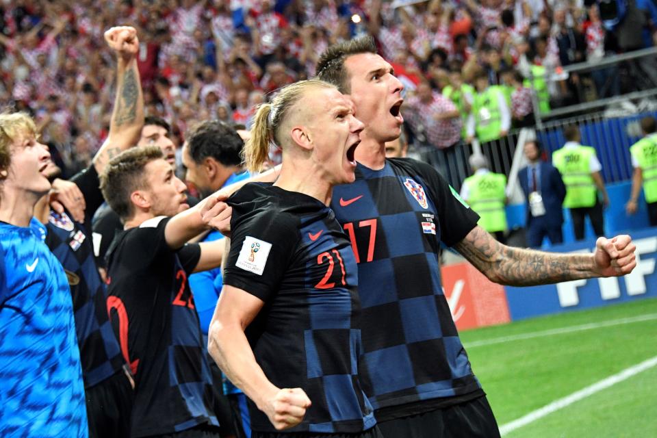 Croatia’s Domagoj Vida and Mario Mandzukic celebrate their victory at the end of the Russia 2018 World Cup semi-final football match between Croatia and England. (Getty Images)