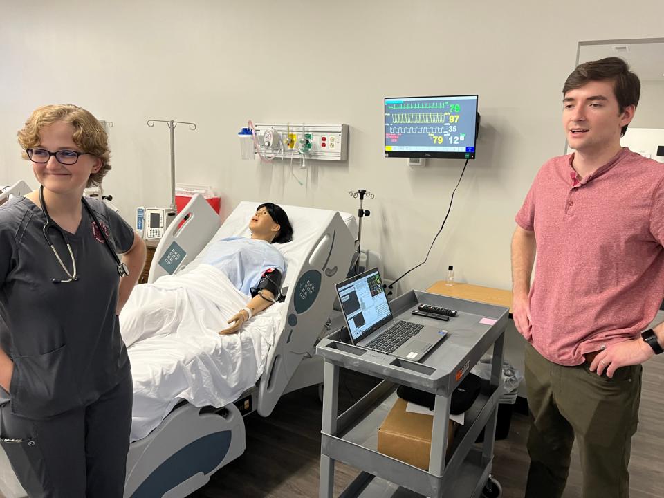 Cumberland University nursing students Carol Anne Clanton, left, and Isaac Wilson demonstrate simulation equipment, including a high-tech mannequin.