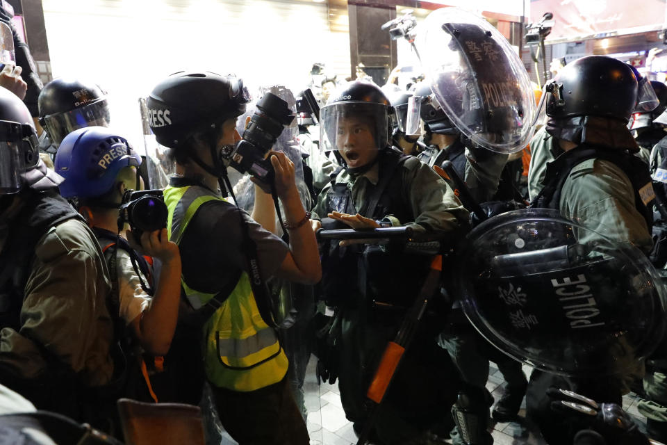 Police push back journalists during a confrontation with protesters in Hong Kong on Saturday, Aug. 10, 2019. Hong Kong is in its ninth week of demonstrations that began in response to a proposed extradition law but have expanded to include other grievances and demands for more democratic freedoms. (AP Photo/Vincent Thian)