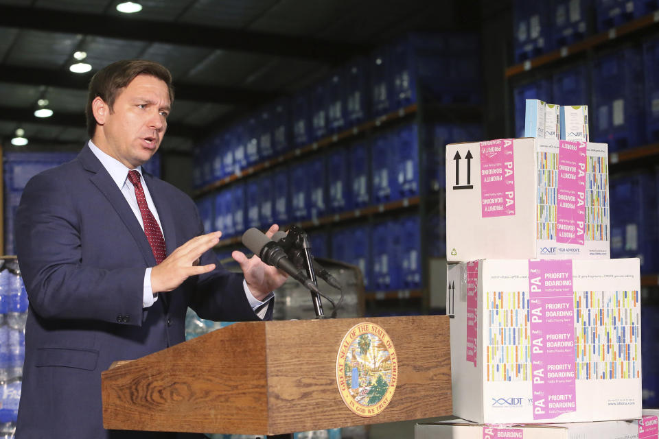 Florida Gov. Ron DeSantis speaks at a news conference at an emergency management warehouse alongside props of testing kits about the spread of the coronavirus, Friday March 13, 2020 in Tallahassee, Fla. The vast majority of people recover from the new coronavirus. According to the World Health Organization, most people recover in about two to six weeks, depending on the severity of the illness. ((AP Photo/Steve Cannon)