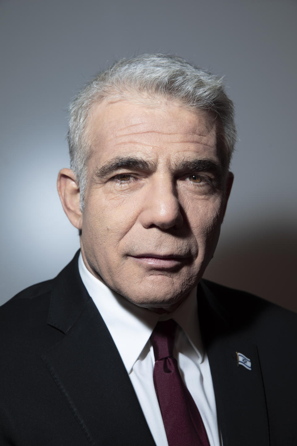 Israel's opposition leader Yair Lapid poses for a photo at his office in Tel Aviv, Israel, Thursday, May 21, 2020. (AP Photo/Oded Balilty)