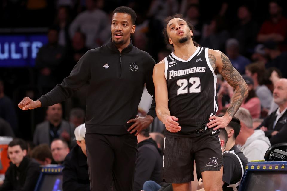 Providence Friars head coach Kim English and guard Devin Carter (22) talk during Friday's game against the Marquette Golden Eagles.