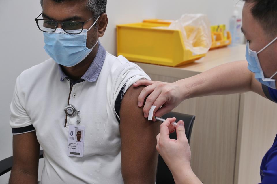 NCID senior consultant Dr Kalisvar Marimuthu receiving his COVID-19 vaccination. (PHOTO: Ministry of Communication and Information)