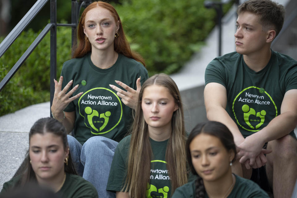 Survivors of the 2012 Sandy Hook Elementary School shooting share their thoughts on high school graduation before a rally against gun violence on Friday, June 7, 2024 in Newtown, Conn. (AP Photo/Bryan Woolston)