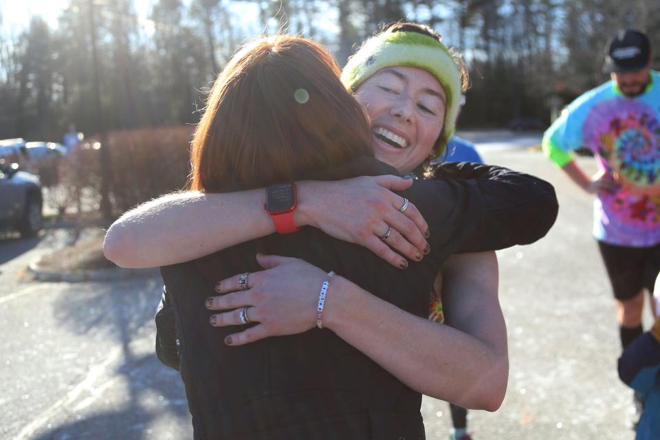 Erinn Needham hugs a supporter after running from Kennebunk to York Hospital in Wells on Friday, December 2, 2022.