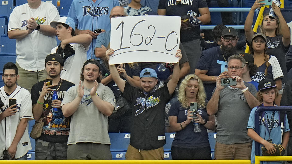 A Tampa Bay Rays fan holds up a sign during the ninth inning of a baseball game against the Oakland Athletics Sunday, April 9, 2023, in St. Petersburg, Fla. The Rays defeated the Athletics to remain undefeated on the season. (AP Photo/Chris O'Meara)