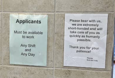 Two signs: One says applicants must be available to work any shift and any day. The other apologizes for short-handedness and promises quick service