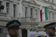 Police stand guard outside the Iranian Embassy after a small group of protesters threw paint at the building in London, Sunday, Sept. 25, 2022. They were protesting against the death of Iranian Mahsa Amini, a 22-year-old woman who died in Iran while in police custody, who was arrested by Iran's morality police for allegedly violating its strictly-enforced dress code. (AP Photo/Alastair Grant)