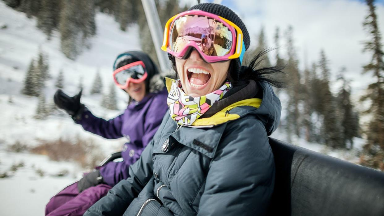 girls laughing and having fun on a chair lift