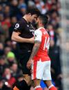 <p>Theo Walcott squares up to Hull’s Harry Maguire</p>