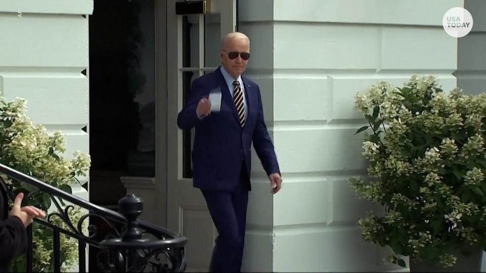 President Joe Biden waves as he walks out of the White House to board Marine One