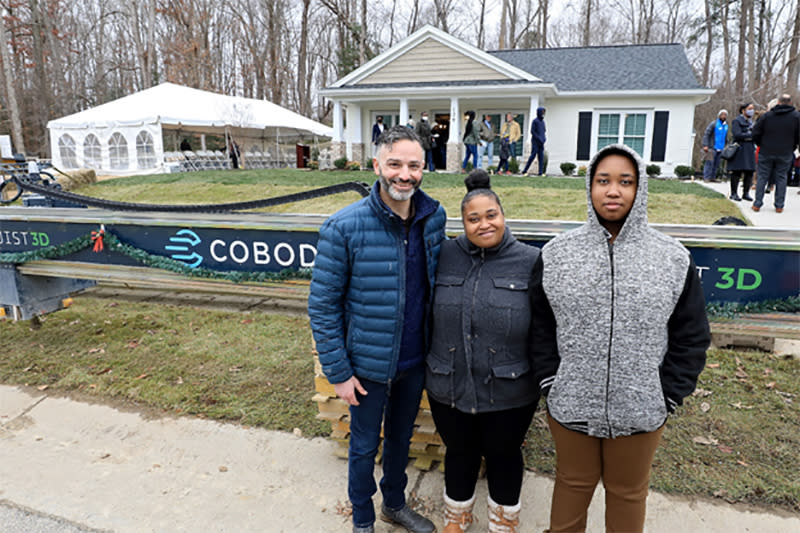 Image: Alquist 3D CEO Zach Mannheimer with new Habitat for Humanity homeowner April in front of her 3D printed home in Williamsburg, Virginia. (Habitat for Humanity)