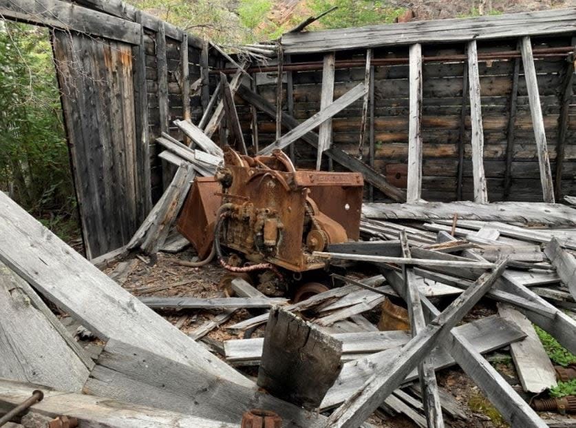A piece of machinery inside a dilapidated wooden structure at the Stark Lake mine site.