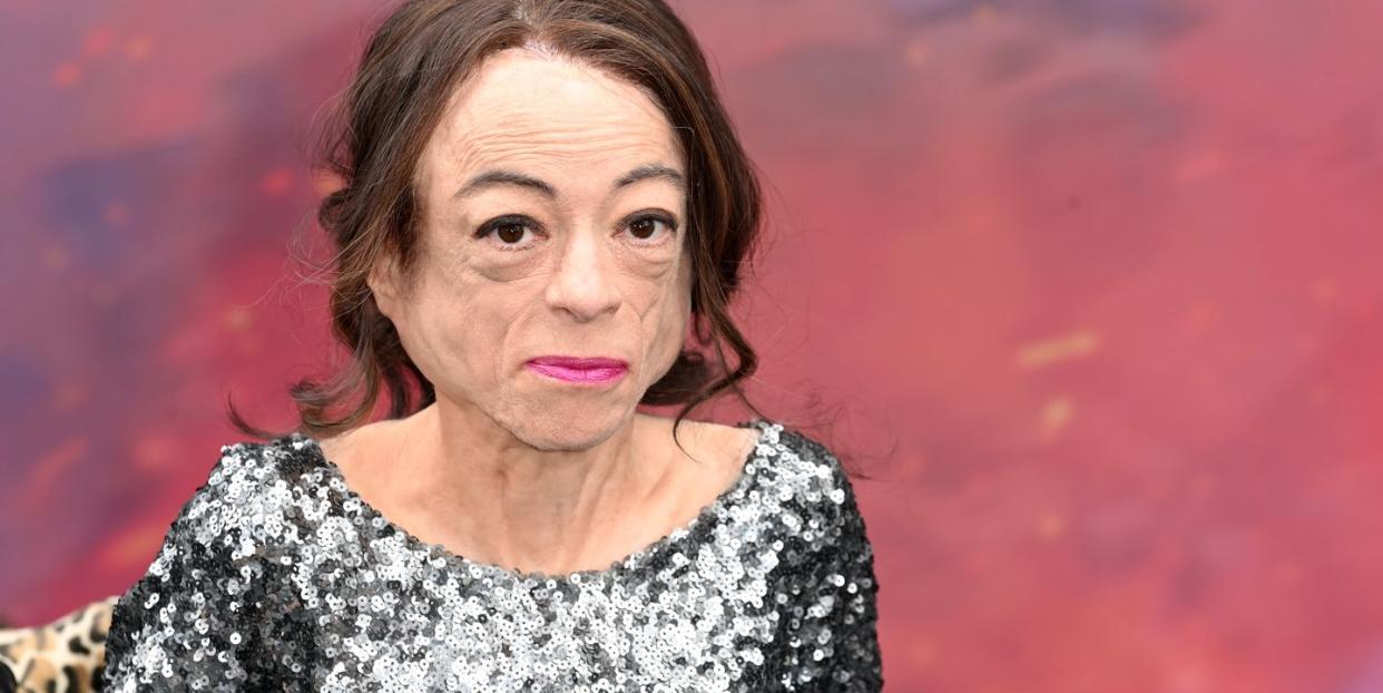 liz carr wearing a silver sequin dress