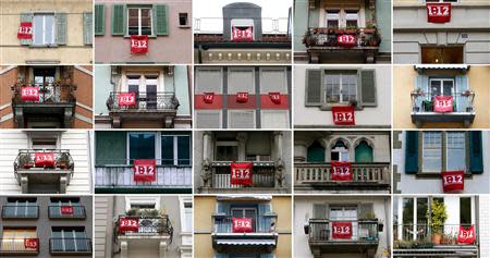 A file combination picture shows '1:12' flags adorning various houses in Bern and Zurich in November 2013. Switzerland will vote November 23, 2013, on whether to limit the salaries of top executives so they don't earn more in a month than the lowest paid workers earn in a year, the latest attempt to put a brake on a growing wage gap in the wealthy nation. The so-called 1:12 initiative for Fair Pay was brought about by the youth wing of the Social Democrats (JUSO), who gathered the 100,000 signatures needed to force a nationwide vote Pictures taken throughout November 2013. REUTERS/Staff/Files