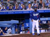 <p>Manager Dave Roberts #30 of the Los Angeles Dodgers walks out of the dugout during a preseason game against the Los Angeles Angels amidst the coronavirus (COVID-19) pandemic at Dodger Stadium on July 21 in Los Angeles.</p>