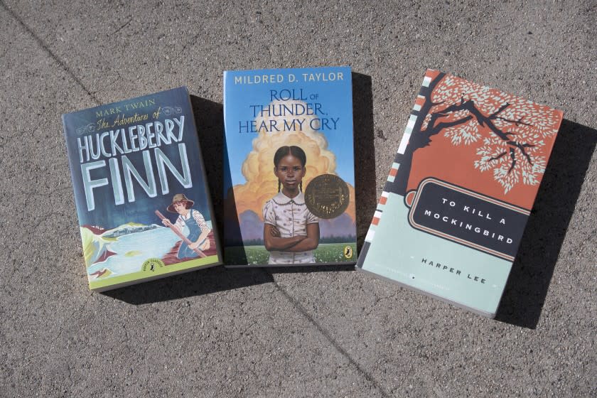 BURBANK, CA - NOVEMBER 08: A view of three of the five books the Burbank Unified School District removed from in-class instruction because of the alleged harm they can cause to the district's Black students. The titles are "The Adventures of Huckleberry Finn," "The Cay," "To Kill a Mockingbird," "Roll of Thunder, Hear My Cry" and "Of Mice and Men." A committee of parents, teachers and principals was created to review the complaints against the books and decide next steps. Chloe Bauer remembers the powerful impact reading "Roll of Thunder, Hear My Cry" had on her when she was a student at John Muir Middle School: it taught her about America's racist history and she believes the novel should remain required reading for Burbank Unified's middle school students. Sungjoo Yoon launched a petition against the books' removal and corralled 80 student statements decrying the district's consideration to permanently remove the books from in-class instruction. Photo taken at John Muir Middle School on Sunday, Nov. 8, 2020 in Burbank, CA. (Allen J. Schaben / Los Angeles Times)