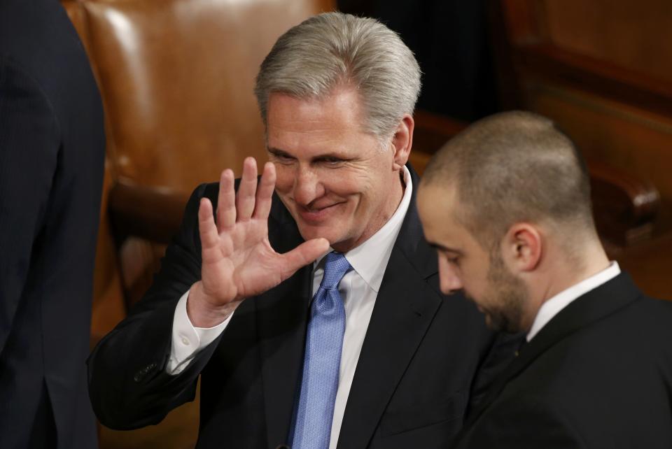 U.S. House Majority Leader McCarthy waves to a colleague on the floor as he waits for U.S. President Obama to deliver his State of the Union address to a joint session of the U.S. Congress on Capitol Hill in Washington
