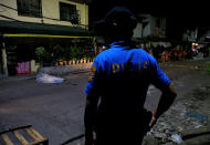 <p>A policeman stands guard near the body of a suspected drug pusher, whom police investigators said was shot and killed by unidentified men, along a street in Quezon city, metro Manila, Philippines March 1, 2017. (Romeo Ranoco/Reuters) </p>