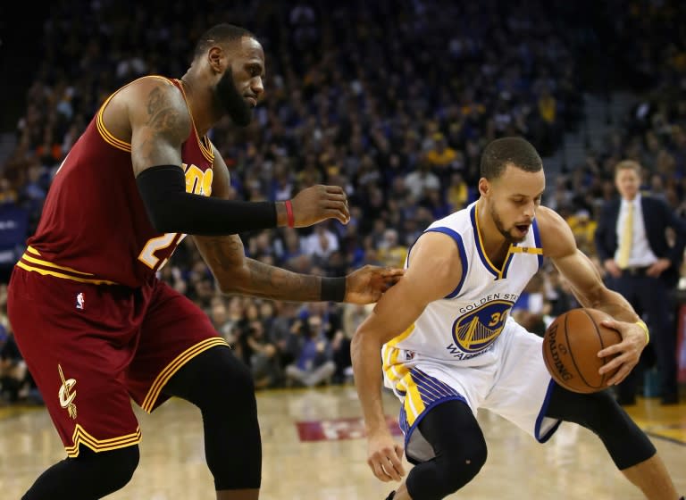 Stephen Curry (R) of the Golden State Warriors steals the ball from LeBron James of the Cleveland Cavaliers, at ORACLE Arena in Oakland, California, in January 2017