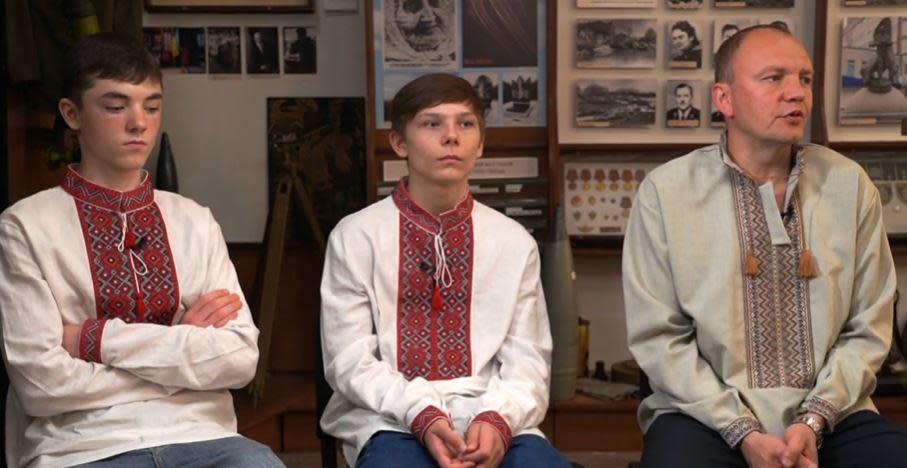 Ukrainian teens Ivan, left and Maxim speak with CBS News about their experience being taken against their wishes to Russia, alongside the man who came to rescue them, Anton Bilay. / Credit: CBS News