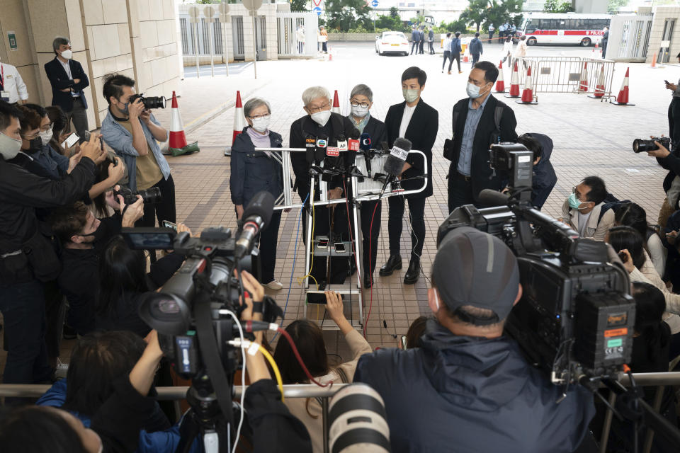 Cardinal Joseph Zen, second from left, speaks to members of the media at the West Kowloon Magistrates's Courts after the verdict session in Hong Kong, Friday Nov. 25, 2022. The 90-year-old Catholic cardinal and five others in Hong Kong were fined after being found guilty Friday of failing to register a now-defunct fund that aimed to help people arrested in the widespread protests three years ago. (AP Photo/Anthony Kwan)