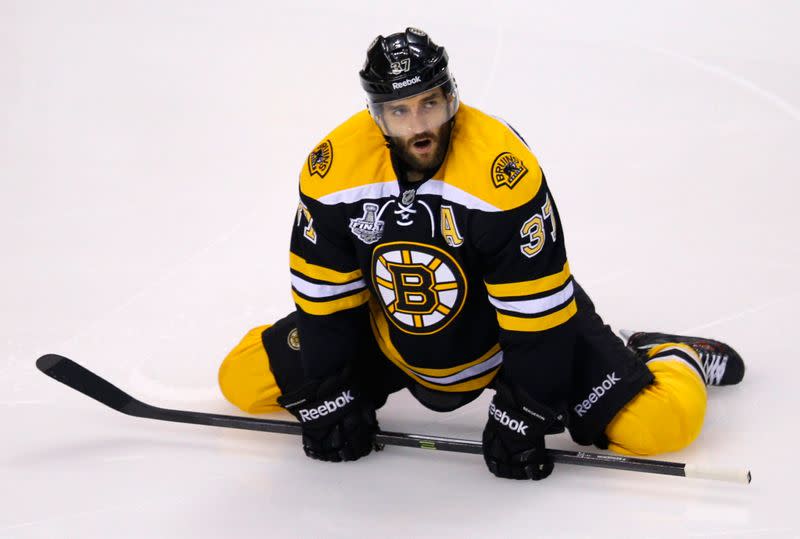 FILE PHOTO: Bruins' Bergeron stretches during the warmup before playing the Blackhawks in Game 6 of their NHL Stanley Cup Finals hockey series in Boston