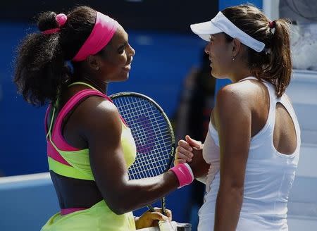 Serena Williams (L) of the U.S. shakes hands with Garbine Muguruza of Spain after winning their women's singles fourth round match at the Australian Open 2015 tennis tournament in Melbourne January 26, 2015. REUTERS/Issei Kato