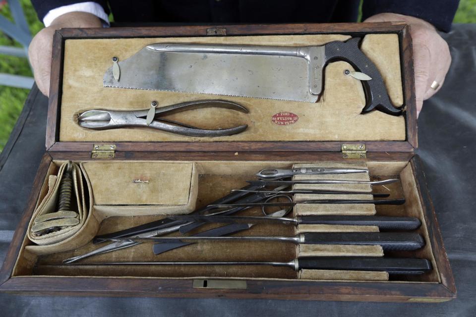 In this Friday, May 24, 2013 photo, Dave Morris, portraying an army surgeon with the 2nd Division 11th Corps Army of Potomac, displays an amputation set at the George Spangler Farm that served as a field hospital during the Civil War, in Gettysburg, Pa. Tens of thousands of visitors are expected for the 10-day schedule of events that begin June 29 to mark 150th anniversary of the Battle of Gettysburg that took that took place July 1-3, 1863. (AP Photo/Matt Rourke)