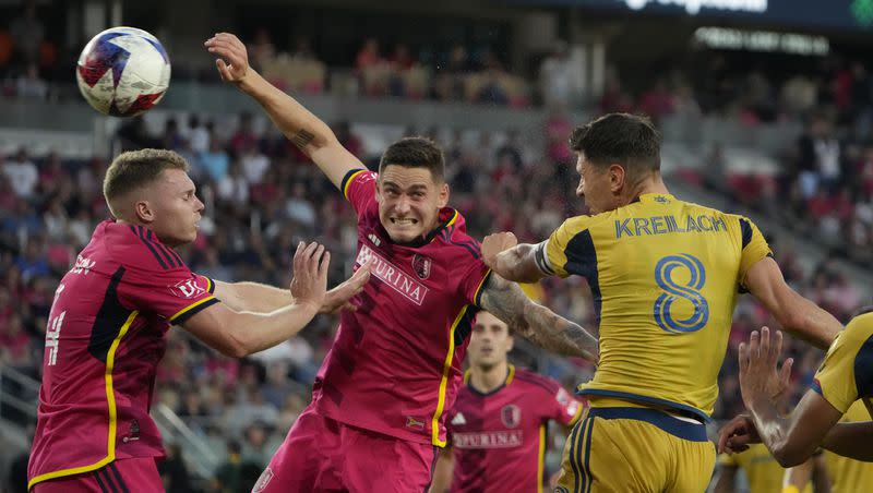 Real Salt Lake’s Damir Kreilach (8) heads the ball past St. Louis City’s Jake Nerwinski (2) and John Nelson (14) during the first half of an MLS soccer match Wednesday, June 21, 2023, in St. Louis.
