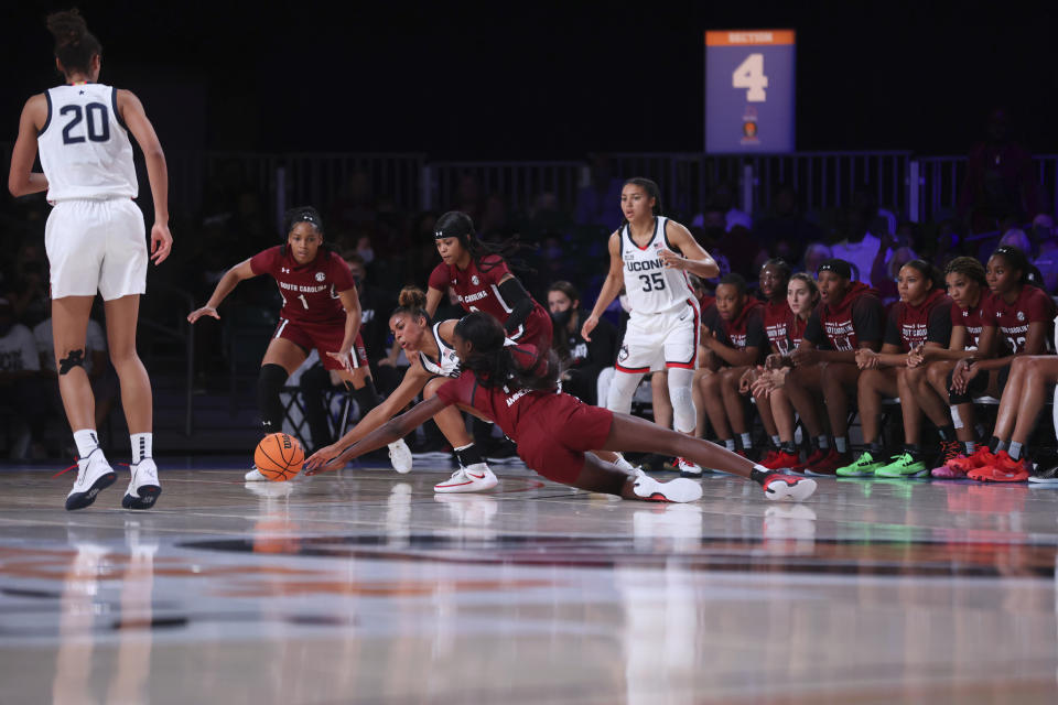 In this photo provided by Bahamas Visual Services, UConn guard Evina Westbrook, center, fights for ball with South Carolina guard Destanni Henderson as UConn forward Olivia Nelson-Ododa (20), South Carolina guard Zia Cooke (1) and UConn guard Azzi Fudd (35) look on during an NCAA college basketball game at Paradise Island, Bahamas, Monday, Nov. 22, 2021. Player at center rear is unidentified. (Tim Aylen/Bahamas Visual Services via AP)