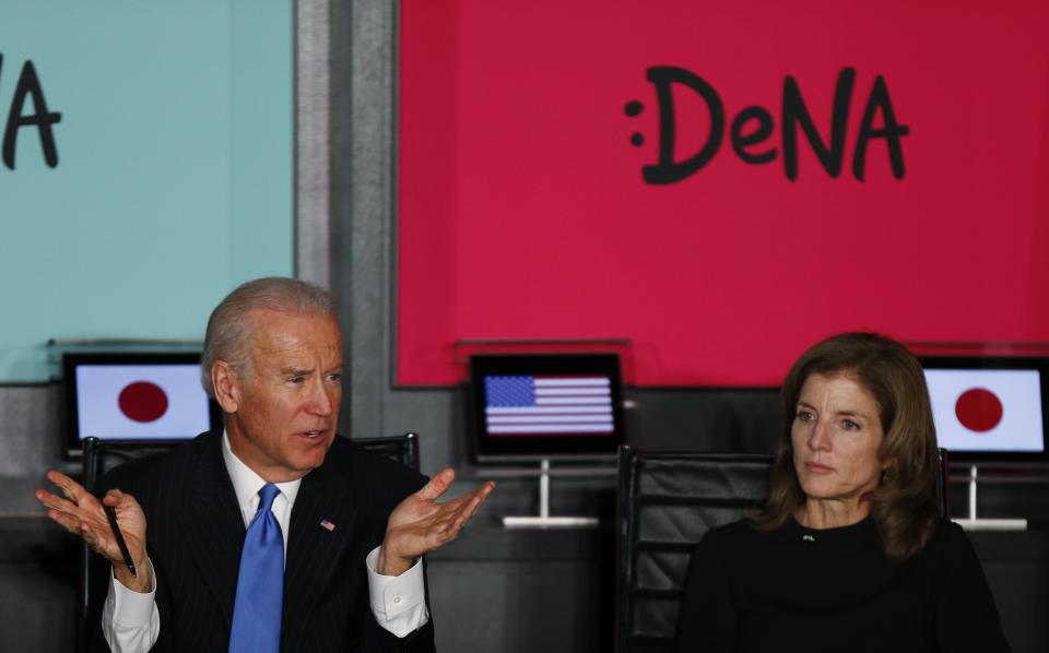 U.S. Vice President Joe Biden, flanked by U.S. Ambassador to Japan Caroline Kennedy, gestures as they meet with Japanese business leaders at the headquarters of internet commerce and mobile games provider DeNA Co. in Tokyo