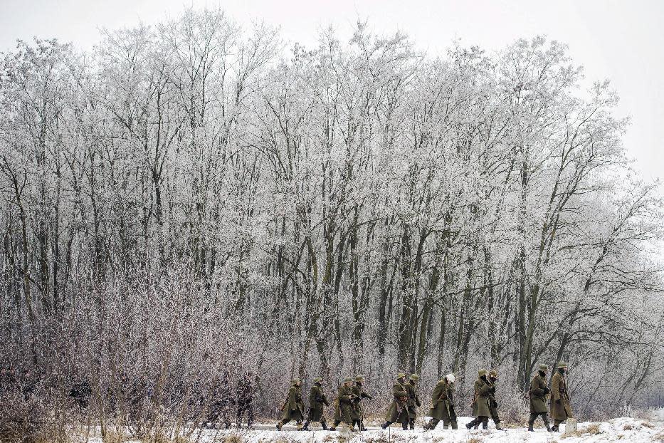 In this photo taken Thursday, Jan. 26, 2017, tradition-keepers dressed as soldiers of the 2nd Hungarian Army march on a road near Debrecen, Hungary, during the 17th Memorial March of Heroes' of Don in honor of victims of World War II. Deployed in the River Don bend area approximately 130 thousand soldiers of the 2nd Hungarian Army were killed, wounded, captured and forced to labor camps by the Soviet Red Army in 1942-1943. For Hungary, a pro-Russian leader in the White House offers hope the Western world might end the sanctions imposed over Russia’s annexation of Crimea and its role in eastern Ukraine. Many Poles, instead, fear a U.S-Russian rapprochement under Trump could threaten their own security interests. To most Poles, NATO represents the best guarantee for an enduring independent state in a difficult geographical neighborhood. (Zsolt Czegledi/MTI via AP)