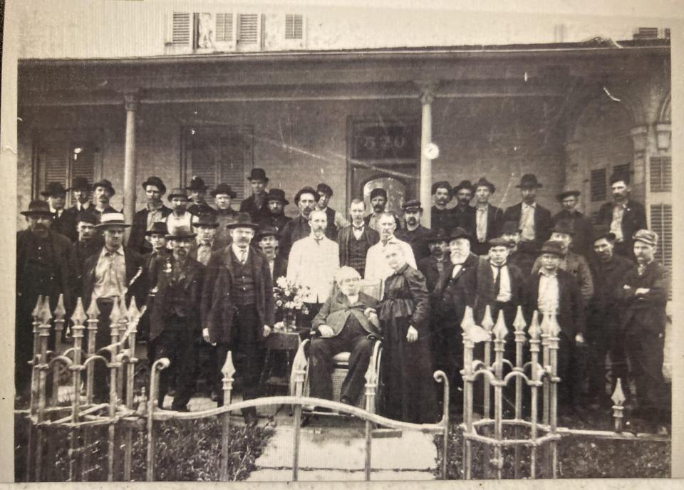 Fremont industrialist David June (1824-1905) is pictured surrounded by family and employees on the front porch of his home.