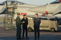 Air Chief Marshal Mike Wigston, left and Station Commander for RAF Coningsby Billy Cooper walk with Britain's Prime Minister Rishi Sunak during his visit to RAF Coningsby in Lincolnshire, England, Friday, Dec. 9, 2022, following the announcement that Britain will work to develop next-generation fighter jets with Italy and Japan. (Joe Giddens/Pool Photo via AP)