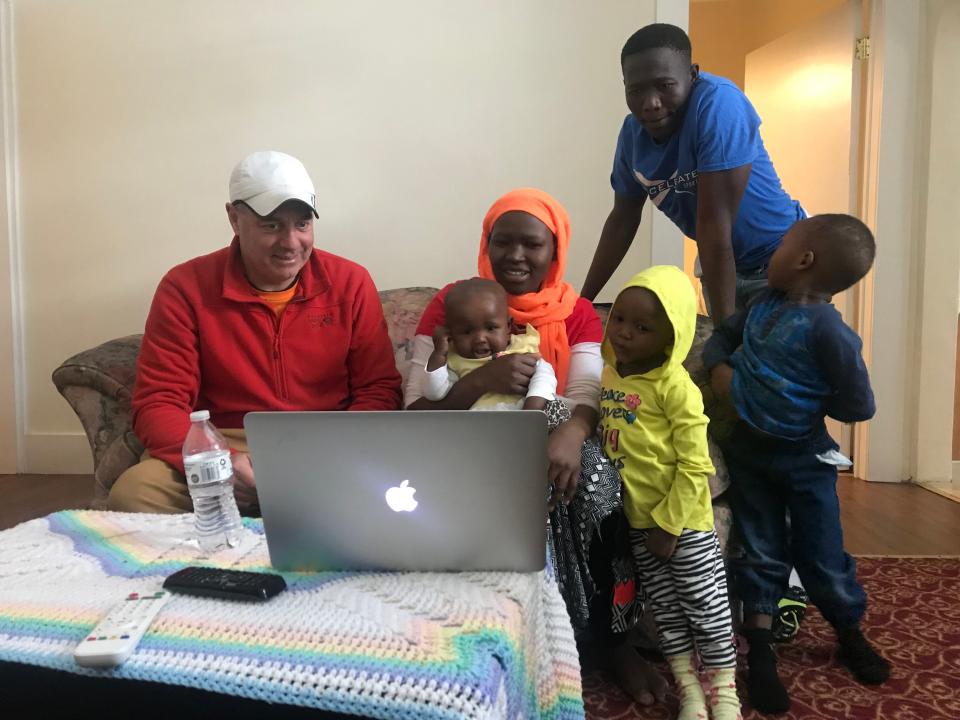 In this 2018 photo, Loch Phillipps, director of "Utica: The Last Refuge" reviews footage he shot for the film with its subjects, the Azein family, who came to the U.S. from Sudan as refugees. Left to right: Phillipps, Yasmin Azein, Nada Azein, Nisren Azein, Nasradin Azein, and Mohamed Azein. The documentary film will be shown for free at the Zeiterion Performing Arts Center in New Bedford on Tuesday, June 13, at 7 p.m. followed by a panel discussion.