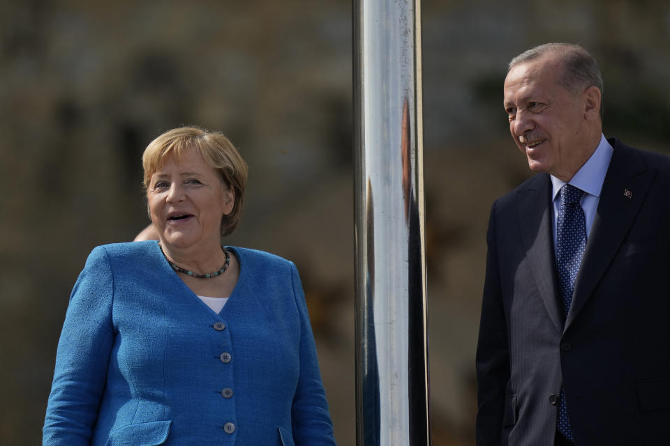 German Chancellor Angela Merkel, left, talks to Turkish President Recep Tayyip Erdogan on the occasion of their meeting at Huber Villa presidential palace, in Istanbul, Turkey, Saturday, Oct. 16, 2021. (AP Photo/Francisco Seco)
