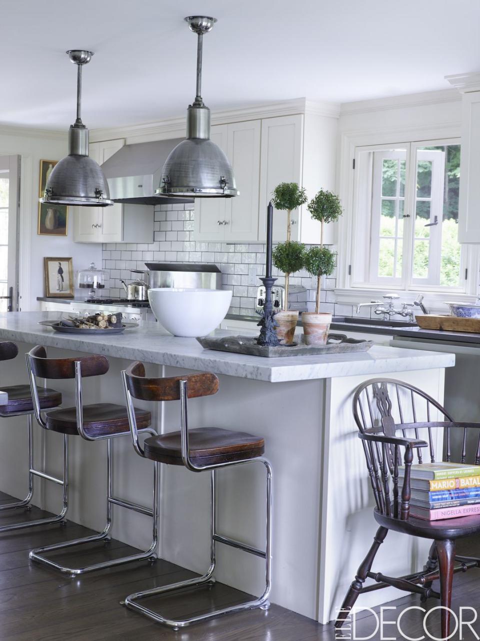 <p>This bright and airy <a href="https://www.elledecor.com/celebrity-style/celebrity-homes/g76/amazing-celebrity-kitchens/" rel="nofollow noopener" target="_blank" data-ylk="slk:kitchen;elm:context_link;itc:0;sec:content-canvas" class="link ">kitchen</a> in a cottage in <a href="https://www.elledecor.com/design-decorate/house-interiors/a8823/connecticut-weekend-house-with-midcentury-design/" rel="nofollow noopener" target="_blank" data-ylk="slk:Connecticut;elm:context_link;itc:0;sec:content-canvas" class="link ">Connecticut</a> keeps it classic with wall tiles from <a href="http://www.waterworks.com" rel="nofollow noopener" target="_blank" data-ylk="slk:Waterworks;elm:context_link;itc:0;sec:content-canvas" class="link ">Waterworks</a>, a stainless steel stove by <a href="http://www.vikingrange.com/consumer/index.jsp" rel="nofollow noopener" target="_blank" data-ylk="slk:Viking;elm:context_link;itc:0;sec:content-canvas" class="link ">Viking</a>, stools by <a href="http://www.yorkstreet.com" rel="nofollow noopener" target="_blank" data-ylk="slk:York Street Studio;elm:context_link;itc:0;sec:content-canvas" class="link ">York Street Studio</a> and 1920s English pendants by <a href="https://www.bkantiques.com" rel="nofollow noopener" target="_blank" data-ylk="slk:BK Antiques;elm:context_link;itc:0;sec:content-canvas" class="link ">BK Antiques</a>. <br></p>