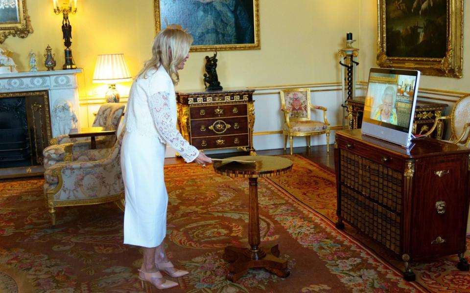 Queen Elizabeth II, in residence at Windsor Castle, appears on a screen via videolink, during a virtual audience to receive the US Ambassador, Jane Hartley, at Buckingham Palace, London, on July 19 - Victoria Jones/PA