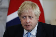 FILE - In this Sept. 5, 2019, file photo, British Prime Minister Boris Johnson takes his seat as he waits for a photo inside Downing Street in London. A Scottish court dealt another blow to Johnson's Brexit plans Wednesday, Sept. 11, ruling that his decision to suspend Parliament less than two months before the U.K. is due to leave the European Union was an unlawful attempt to avoid democratic scrutiny. (AP Photo/Alastair Grant, Pool, File)