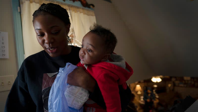 Ansonia Lyons carries her son, Adrien Lyons, as she takes him for a diaper change in Birmingham, Ala., on Saturday, Feb. 5, 2022. After two miscarriages, Ansonia became pregnant in 2020, and it was difficult. Doctors initially told her she was suffering from regular morning sickness, though she was vomiting blood. Ultimately, she was diagnosed with an excessive vomiting disorder. The number of maternal deaths in the U.S. declined in 2022 after several years of increases, according to new data from the Centers for Disease Control and Prevention, released Thursday, May 2, 2024.