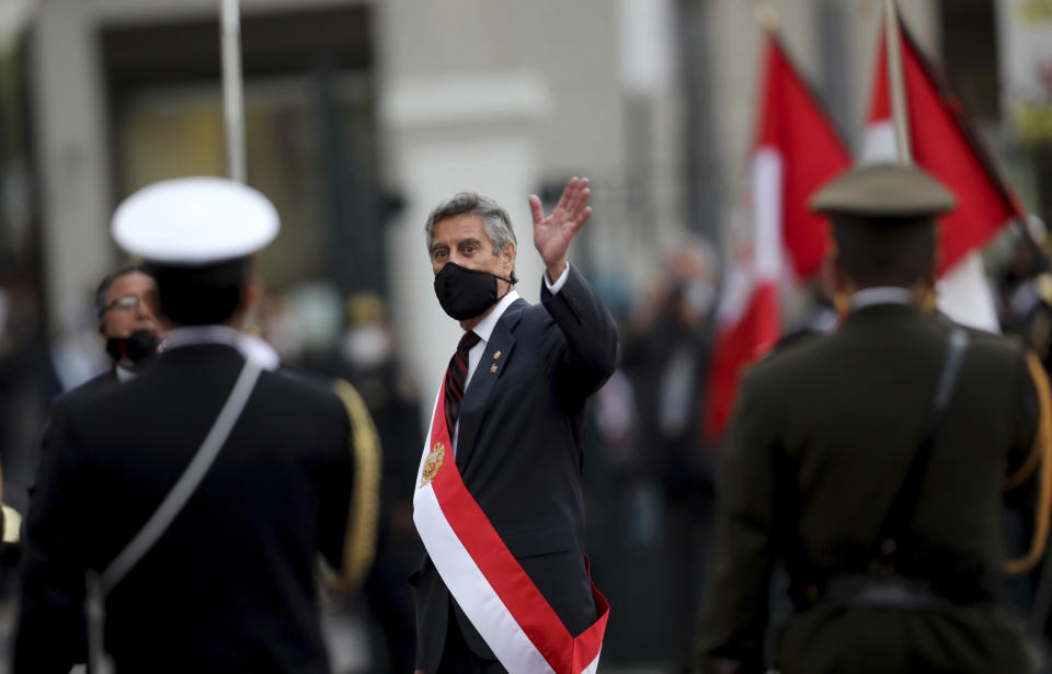 Francisco Sagasti waves after being sworn-in as the new, interim president at Congress in Lima, Peru, Tuesday, Nov. 17, 2020. Sagasti's appointment marks a tumultuous week in which thousands took to the streets outraged by Congress' decision to oust popular ex-President Martín Vizcarra. (AP Photo/Rodrigo Abd)