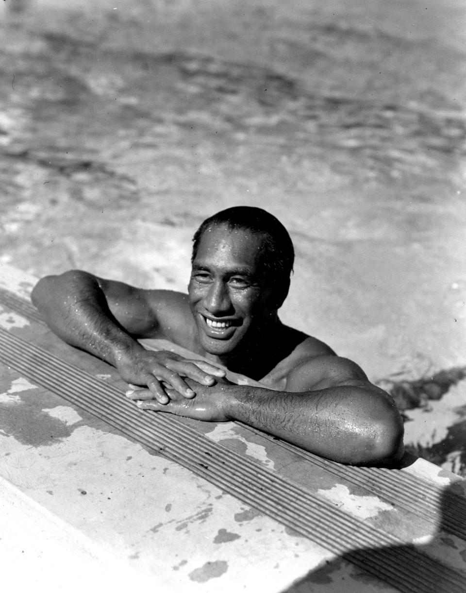 FILE - In this Aug. 11, 1933, file photo, Duke Kahanamoku, Hawaiian Olympic swimmer, poses in a swimming pool in Los Angeles. For some Native Hawaiians, surfing's Olympic debut is both a celebration of a cultural touchstone invented by their ancestors, and an extension of the racial indignities seared into the history of the game and their homeland. Kahanamoku was a Native Hawaiian swimmer who won five Olympic medals and is known as the godfather of modern surfing who introduced the sport in surfing exhibitions in Australia and California. (AP Photo/File)