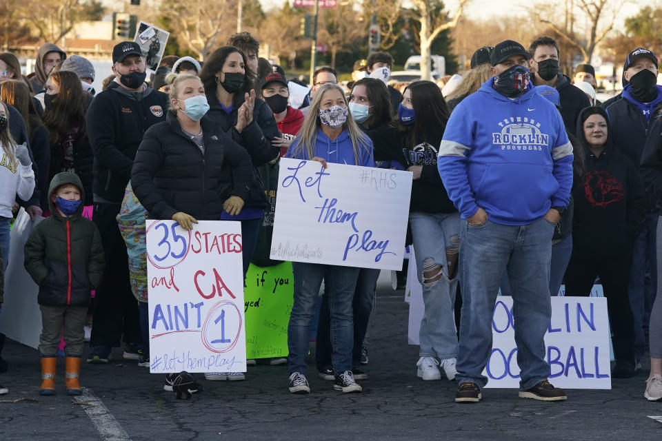 People gather at a "Let Them Play Rally" calling for Gov. Gavin Newsom to allow the state's school children to participate in sports, held in Citrus Heights, Calif., Friday, Jan. 29, 2021. In his efforts to get California schoolchildren back in classrooms, Newsom has met with roadblocks from school superintendents and the the country's most powerful teacher's unions.(AP Photo/Rich Pedroncelli)