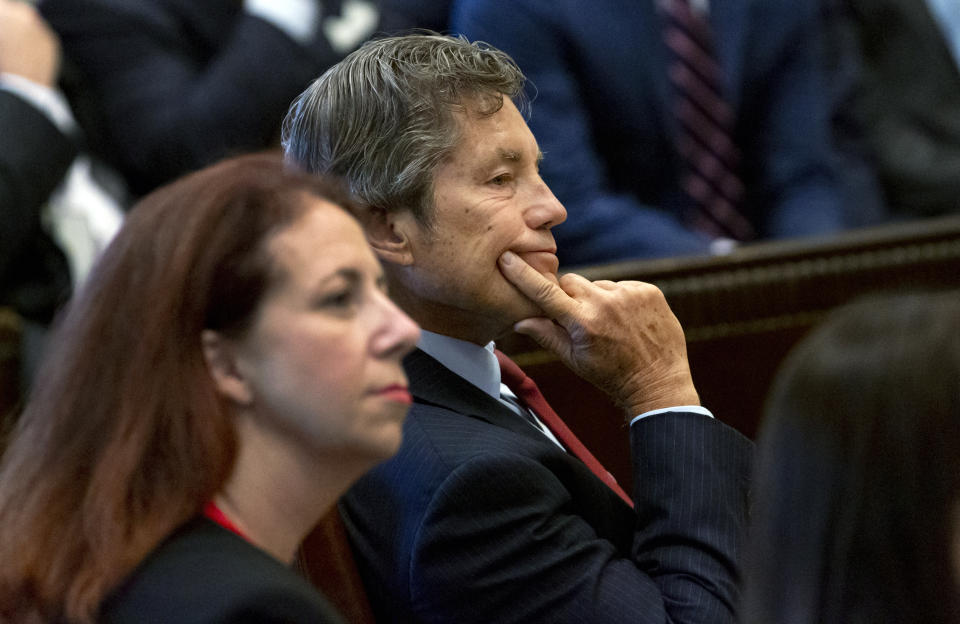 Defense attorney Larry Ottaway, right, listens as Judge Thad Balkman reads a summary of his decision in the opioid trial at the Cleveland County Courthouse in Norman, Okla., Monday, Aug. 26, 2019. Balkman ruled in favor of the state of Oklahoma and ordered Johnson and Johnson to pay $572 million to a plan to abate the opioid crisis. (Chris Landsberger/The Oklahoman via AP, Pool)