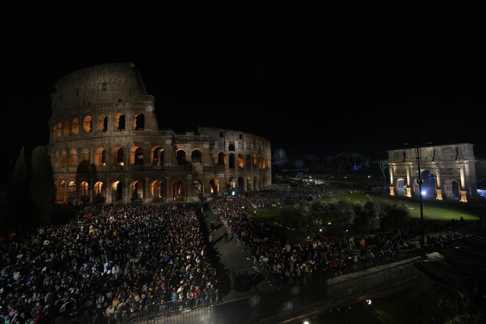 People hold candles during a Via Crucis (Way of the Cross) torchlight procession on Good Friday, in Rome, Friday, March 29, 2024. (AP Photo/Andrew Medichini)